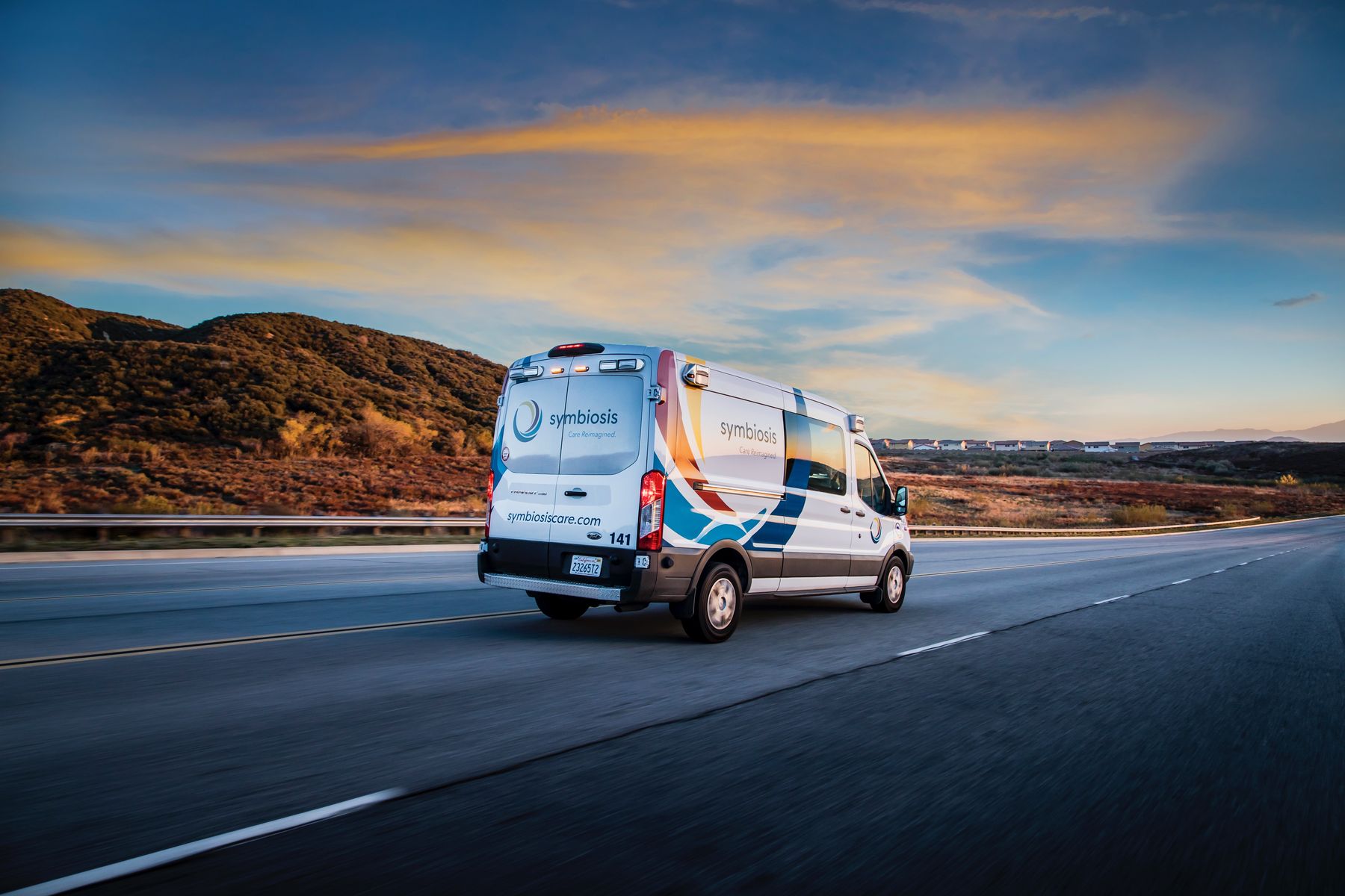 Symbiosis transport van driving on the highway at sunset